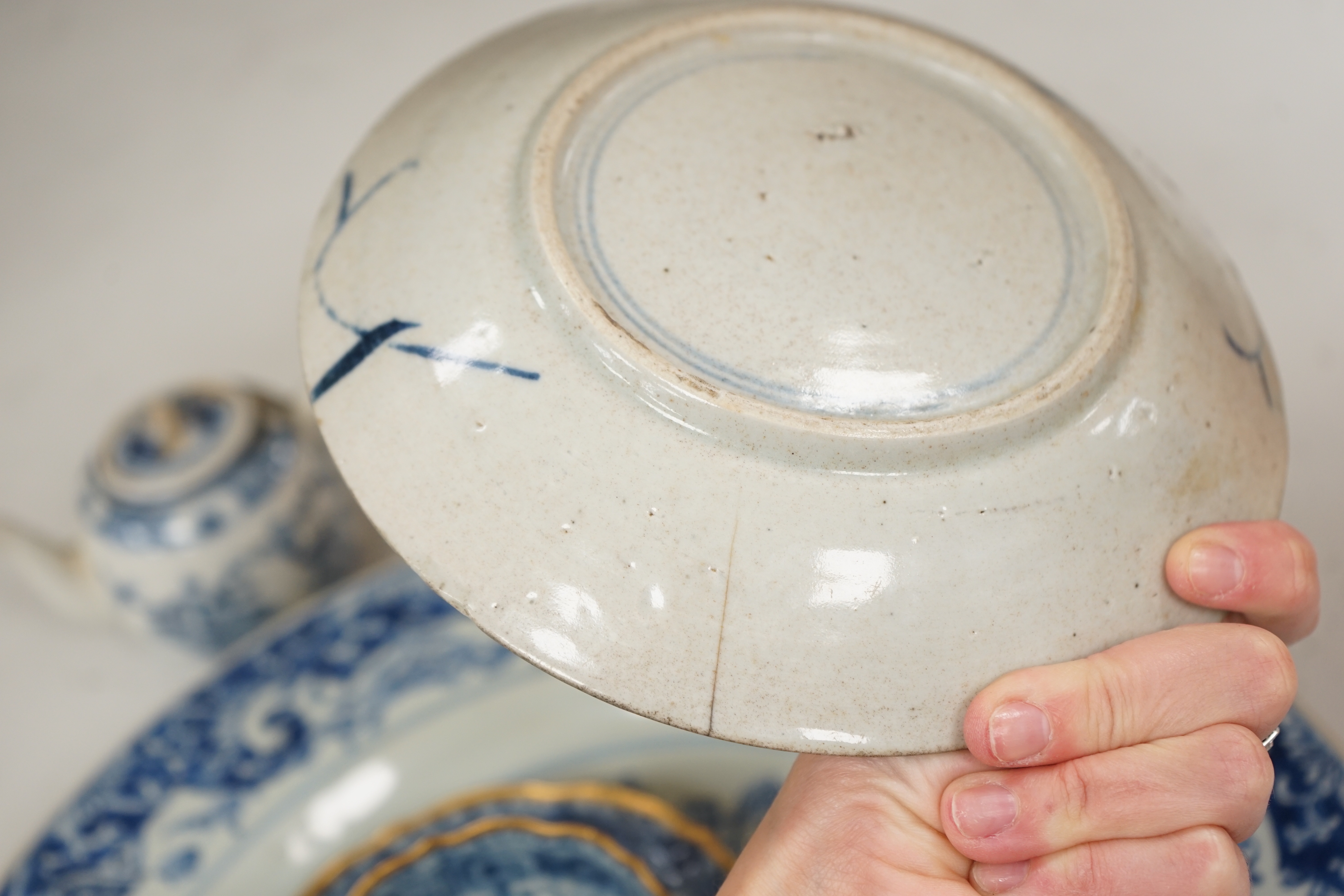 A Worcester teapot, c.1770, two 18th century Chinese porcelain dishes, a cup and saucer, a Chinese shallow bowl and a small teapot, largest dish 39cm